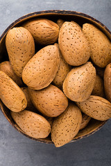 Group of almond nuts with leaves.Wooden background.