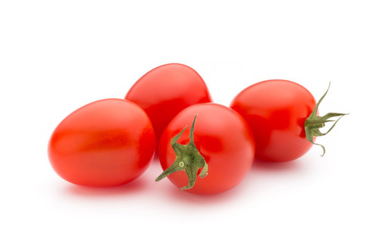 Small plum tomatoes on a white background.