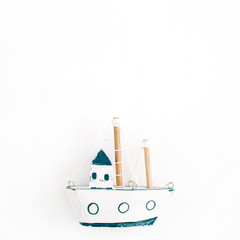 Wooden handmade toy boat on white background. Flat lay, top view
