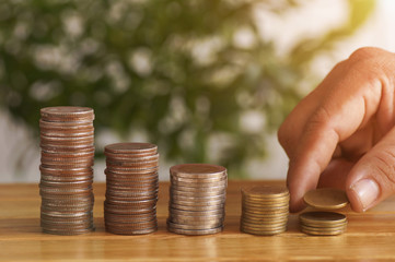 stacked coin on table  for background.concept in grow and walk step by step money for success in business