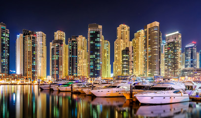Naklejka premium Colorful night dubai marina skyline. Luxury yacht dock. Dubai, United Arab Emirates.