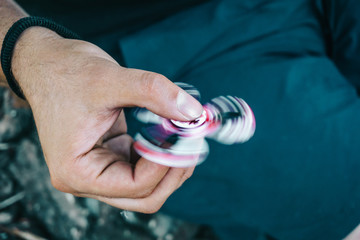 Man hand holding fidget spinner toy