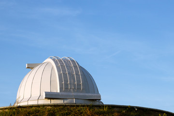 White dome of a large telescope in the Observatory