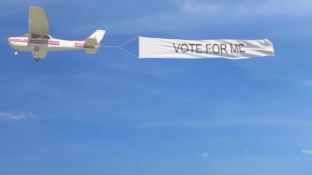 Small propeller airplane towing banner with VOTE FOR ME caption in the sky. 4K clip