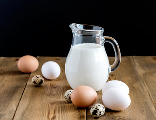 Milk and eggs Wooden background