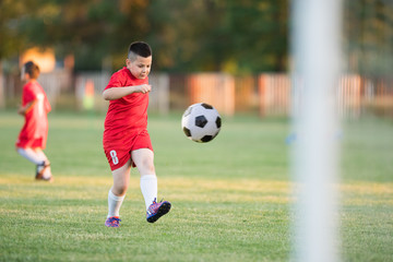 Kids soccer football - children players match on soccer field