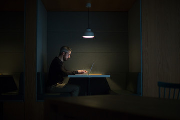 Businessman working late at night in office alone