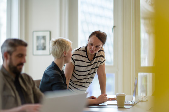Manager training new employee in office