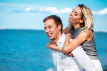 Couple in love having fun laughing and smiling at beach