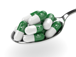 3d render of B9 folic acid pills on spoon