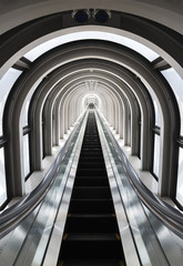Futuristic tunnel and escalator of steel and metal, interior view. Futuristic background, business concept