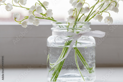 Bouquet Of Lilies Of The Valley Is In A Simple Glass Vase On