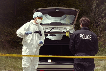 Police team working on abandoned car outdoor