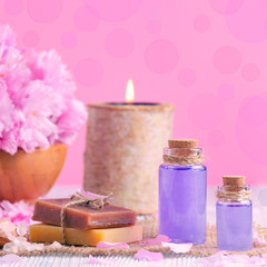 lavender oil, soap, salt, fresh flowers, candle, on pink, for spa and wellness, toned