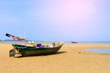 Naklejka na ściany i meble Beautiful blue sky on the wooden fishing boat on a sand beach