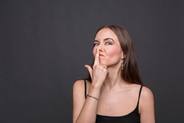 Young woman joking and touching her nose