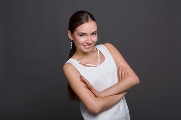 Smiling woman standing with crossed arms