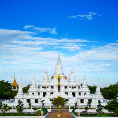 A large, elaborate white Buddhist Pagoda with multiple spires at Wat Asokara Temple in Thailand