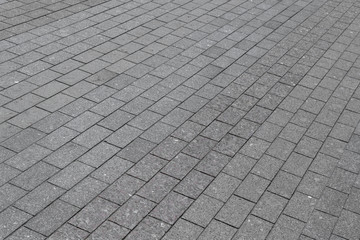 The square or the pavement of granite or marble rectangular tile grey color.