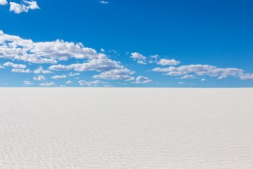 white sand dunes with blue sky