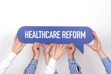 Group of people holding the HEALTHCARE REFORM written speech bubble