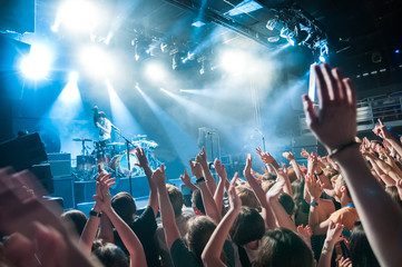 crowd with raised nands during concert at the concert club