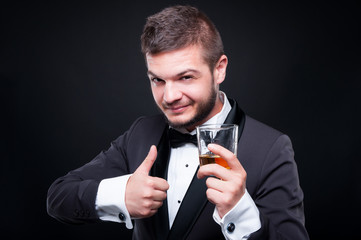 Portrait of man toasting with glass of alcohol