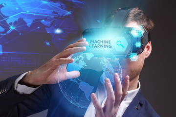 Business, Technology, Internet and network concept. Young businessman working on a virtual screen of the future and sees the inscription: Machine learning