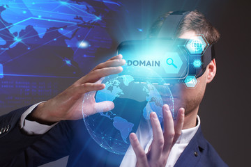 Business, Technology, Internet and network concept. Young businessman working on a virtual screen of the future and sees the inscription: Domain
