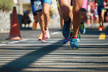 Marathon running race, people feet on city road