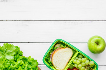 healthy food in lunchbox for dinner at school white table background top view mockup