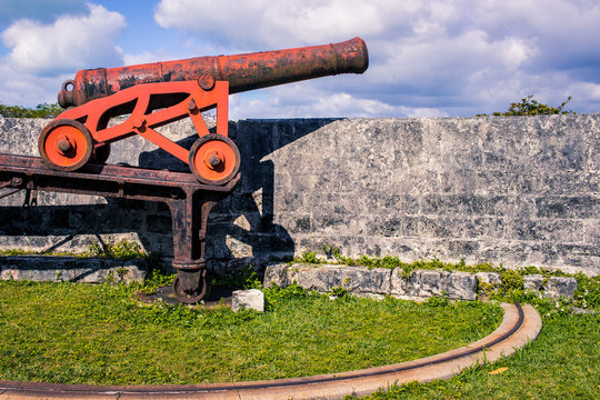 Red cannon on chassis in colonial fort