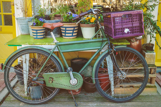 Vintage bicycle with table and garden plants in Amsterdam