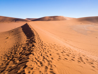 Fototapeta na wymiar Footprints on the way to Dead Vlei on the Namib Desert