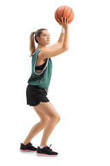 Fototapeta premium Young woman throwing a basketball
