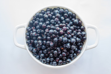 Tasty blueberries fruit in bowl. Blueberries top view.