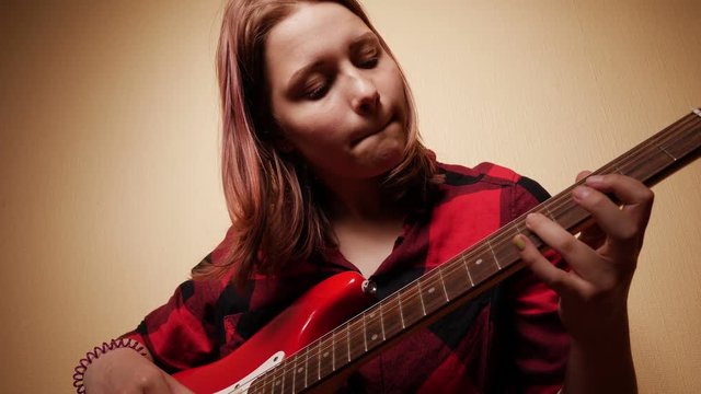 Teen Girl Playing Guitar At Home. Close-Up 4K Slow motion