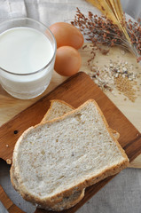 Above Shot of Whole Grain Bread with Milk and Eggs on Background