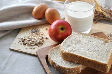 Whole Grain Bread with Glass of Milk on Background