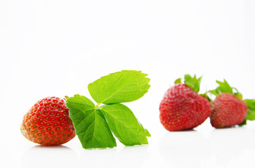 Fresh, ripe, juicy and mouth-watering strawberries with green leaves