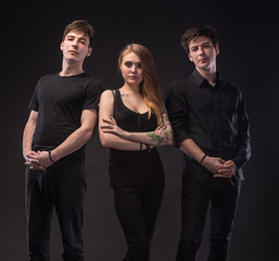 Young woman posing with two young man