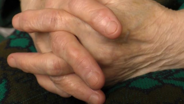 Hands of an elderly woman joined together