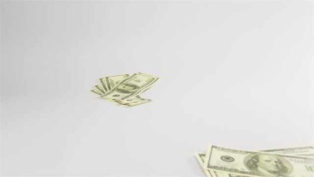 Slow motion. Few Dollars banknotes rain fall on white surface cyclorama. 100 nominal