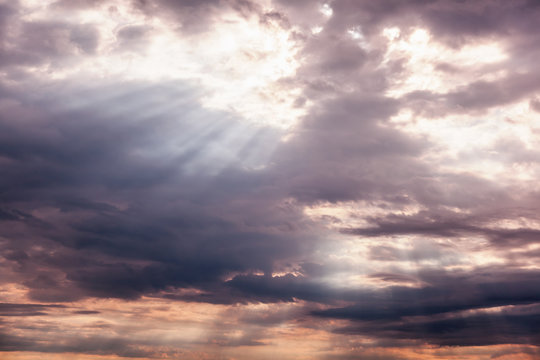 Beautiful dramatic sunset cloudy sky with sun rays. Natural background and texture, abstract image