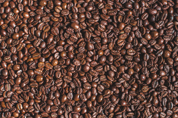 close up of heap of roasted aromatic brown coffee beans