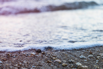 Sea foam rolling in over a rocky beach in Lagos, Portugal