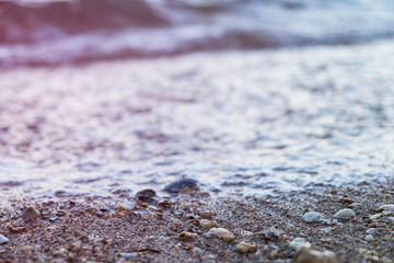 Sea foam rolling in over a rocky beach in Lagos, Portugal