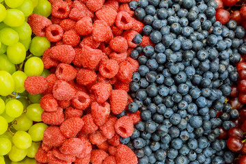 Raspberries, blackberries, blueberries a gray abstract background. Copyspace. Healthy food concept.