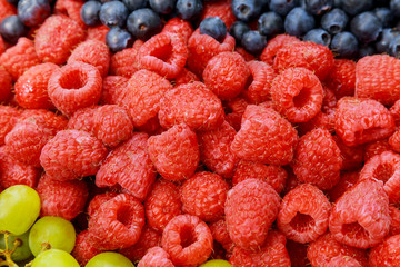 Close up view on ripe blueberry and raspberry
