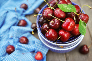 Sweet fresh cherries in blue bowl